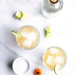 Spicy habanero ginger beer margaritas in glasses with ice, lime and salt