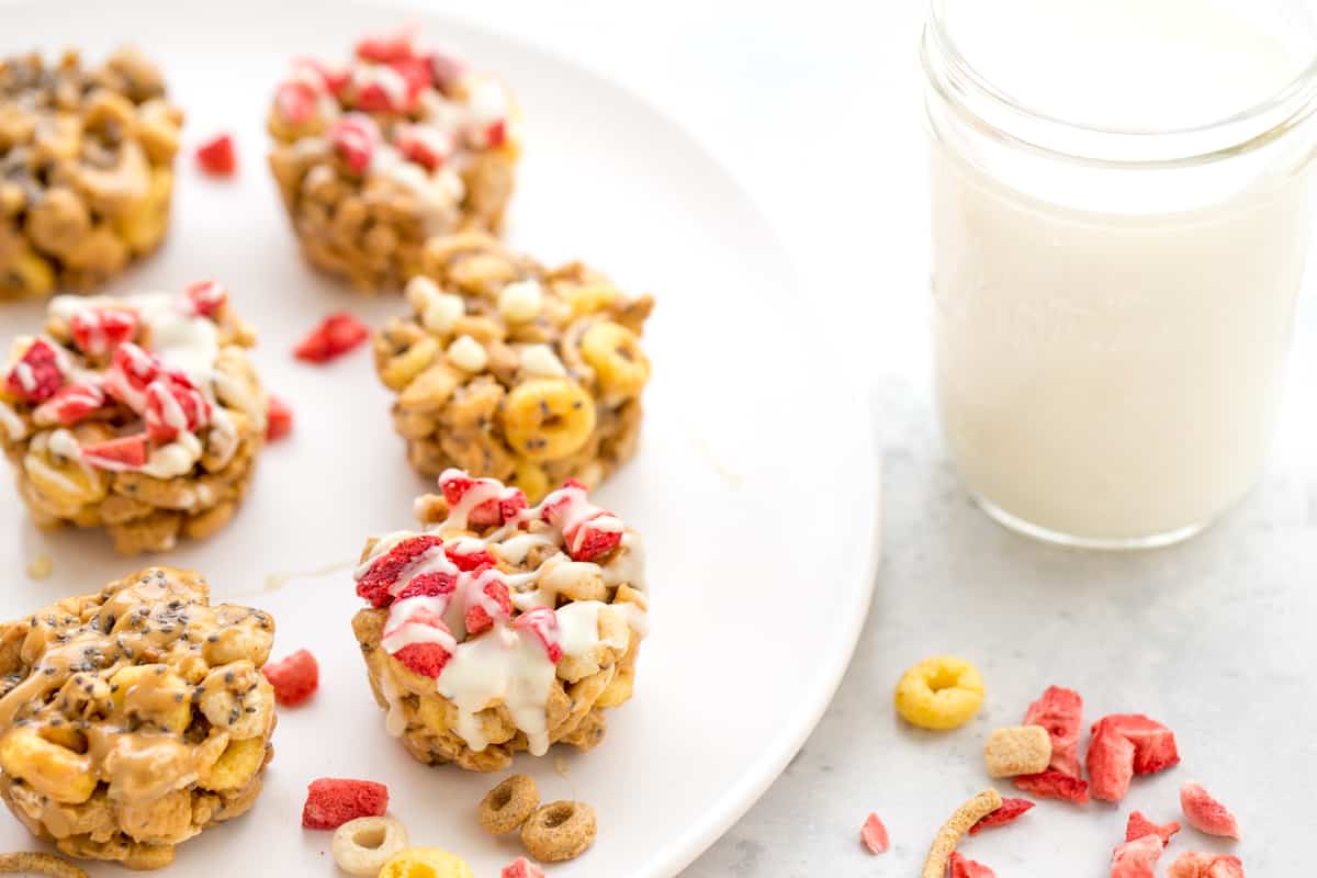 no-bake peanut butter cereal cups on a plate with a mason jar of milk in the background